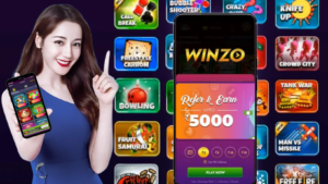 A woman holding up a smartphone with the words "winzoo" on the screen. She seems excited about something she sees on her phone.
